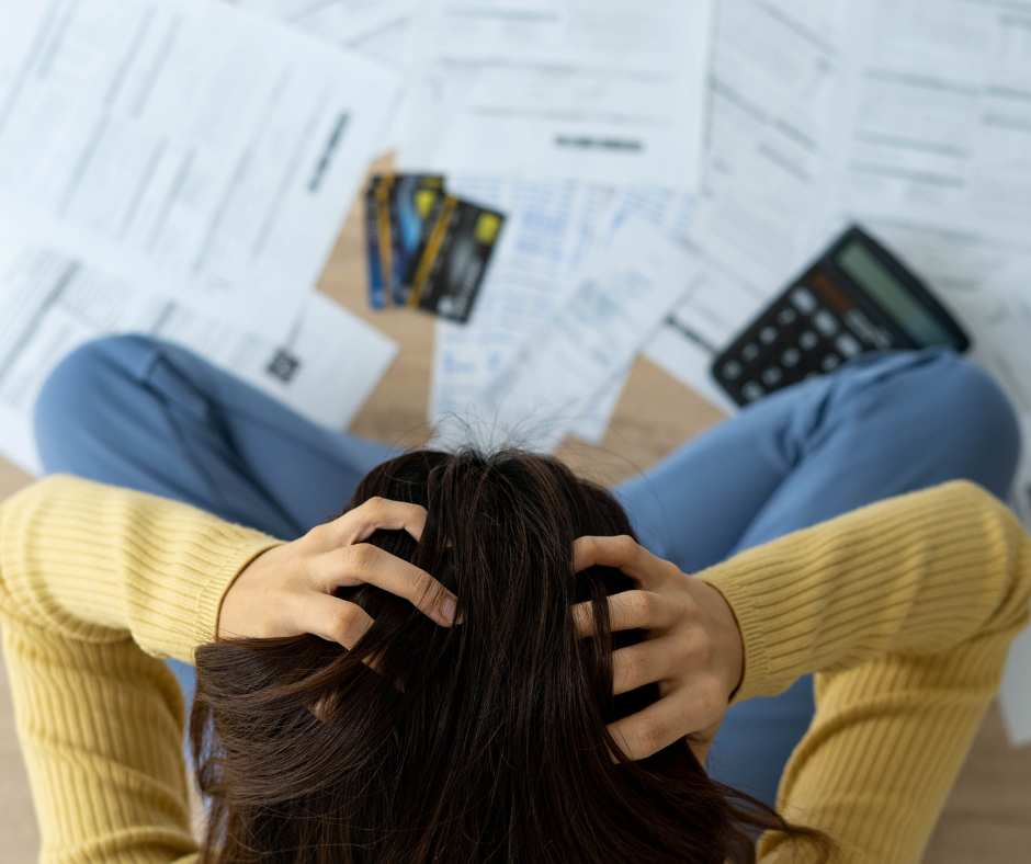 Woman stressed looking at all the late bills