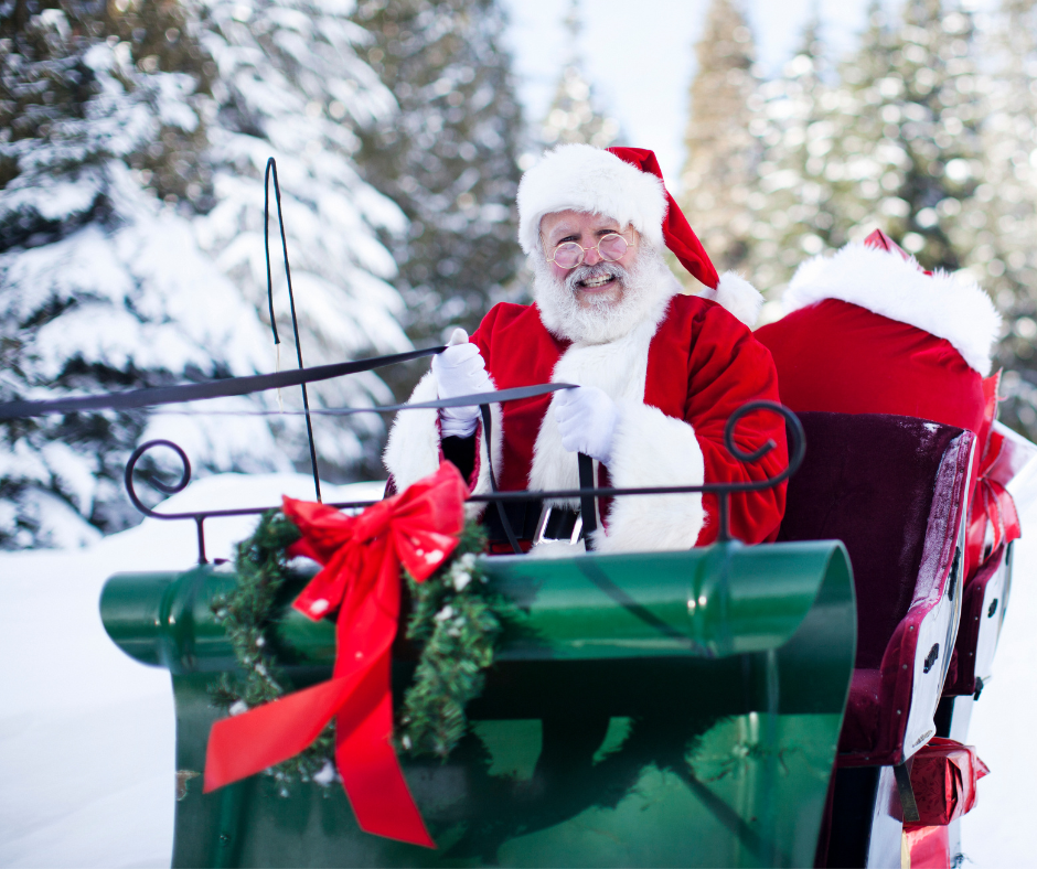 Santa Claus sitting in a green sleigh.
