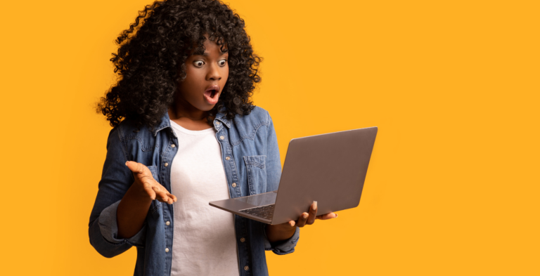 Lady on laptop shocked by financial scam