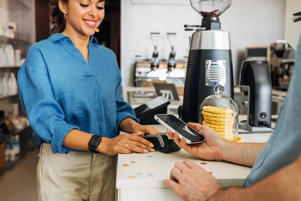 Paying for coffee with a mobile phone.