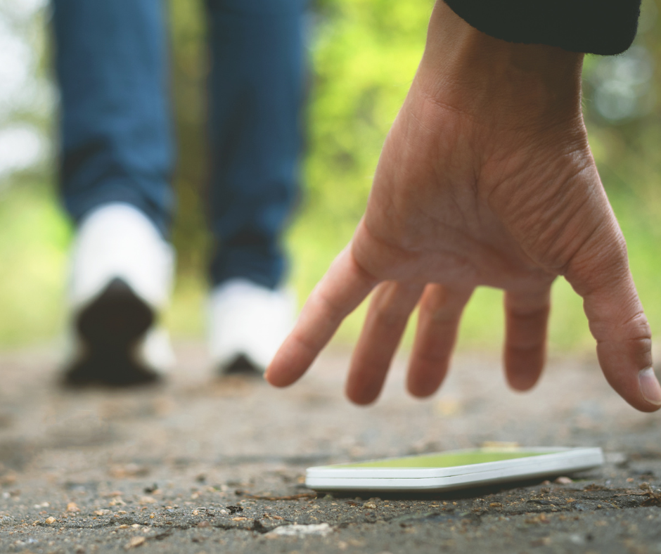 Someone picking up a phone that was lost