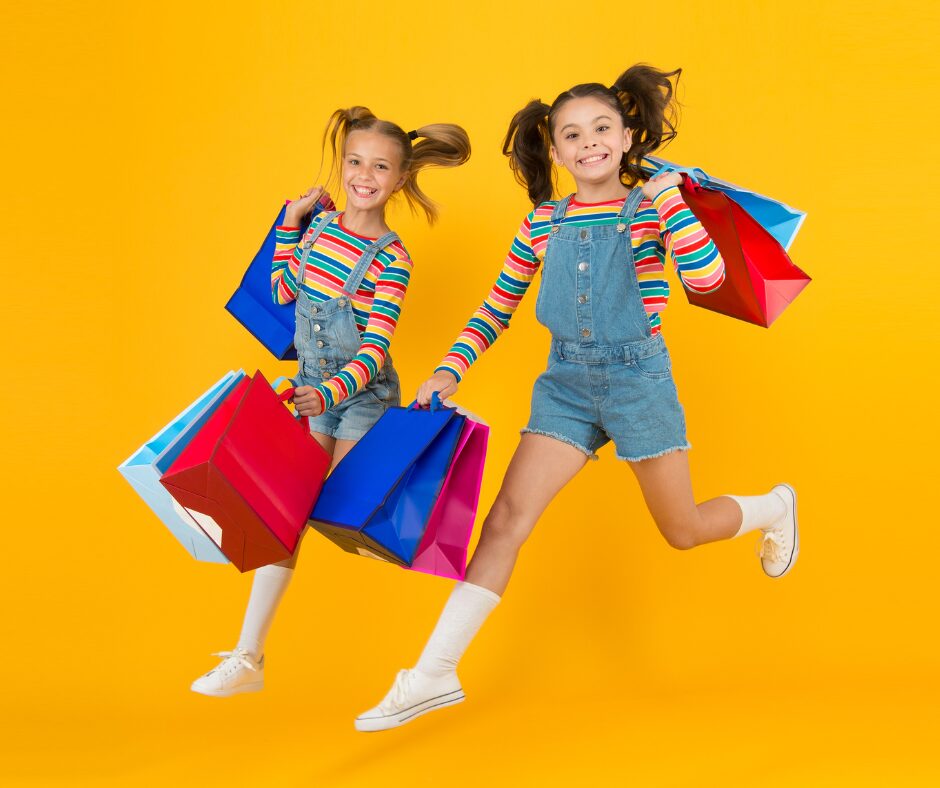 Young girls skipping while shopping during tax free shopping